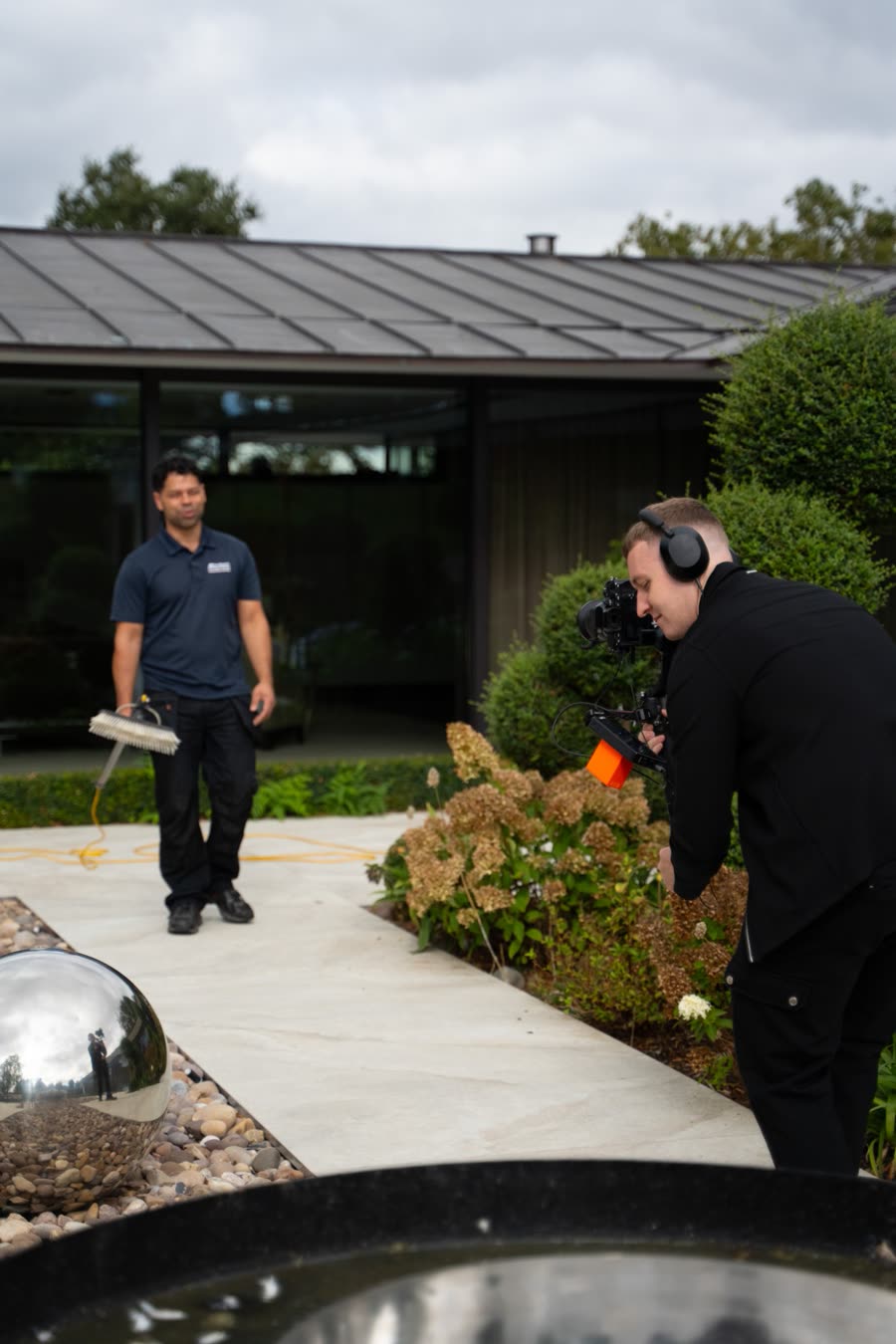 Louie filming the client in their garden